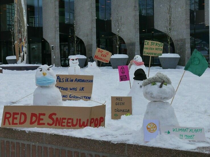 Klimaatvrezende sneeuwpoppen houden de wacht voor het stadhuis